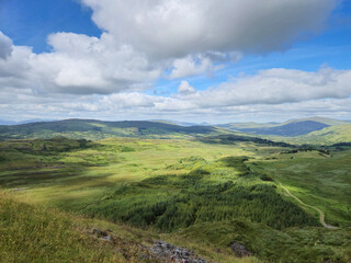 Green hills under blue summer sky landscape in Ireland
