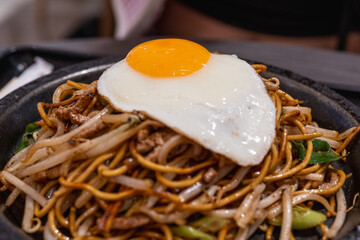 Japanese fried noodles served with uncooked fresh eggs