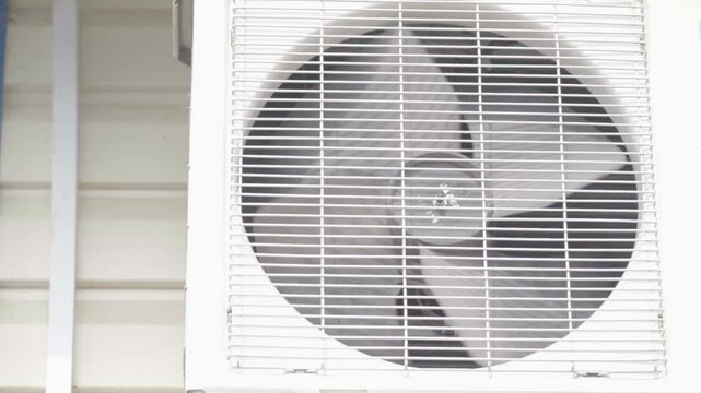air conditioner fan close-up. Operation of the external air conditioner unit in hot weather.