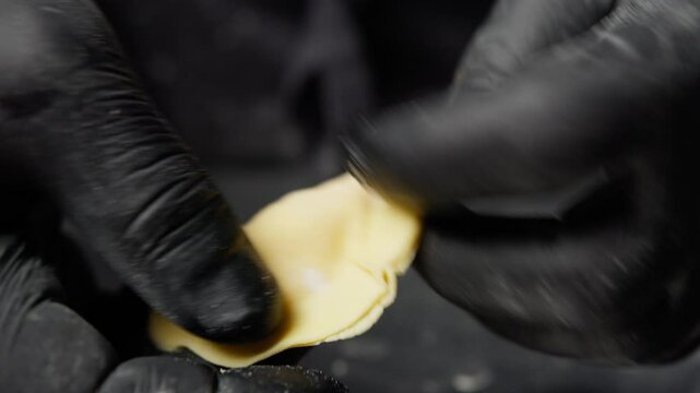 Chef In Black Gloves Creating Stuffed Pasta 