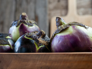 berenjena redonda o berenjena de florencia. Melanzana di firenze sobre fondo r&uacute;stico