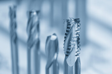 Close-up scene the group of new rough cutter end mill tool in the light blue scene.