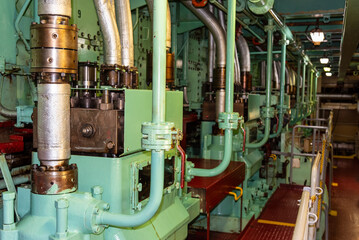 Close-up of a group of fuel injection pumps mounted along the cylinder block of a low-speed marine...
