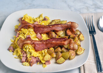 scramble eggs with diced spam with home fries and bacon