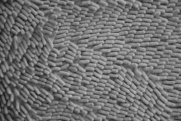 Processed image of fluffy gray doormat from bathroom in grey color