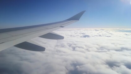 Obraz premium Airplane Wing Above Clouds