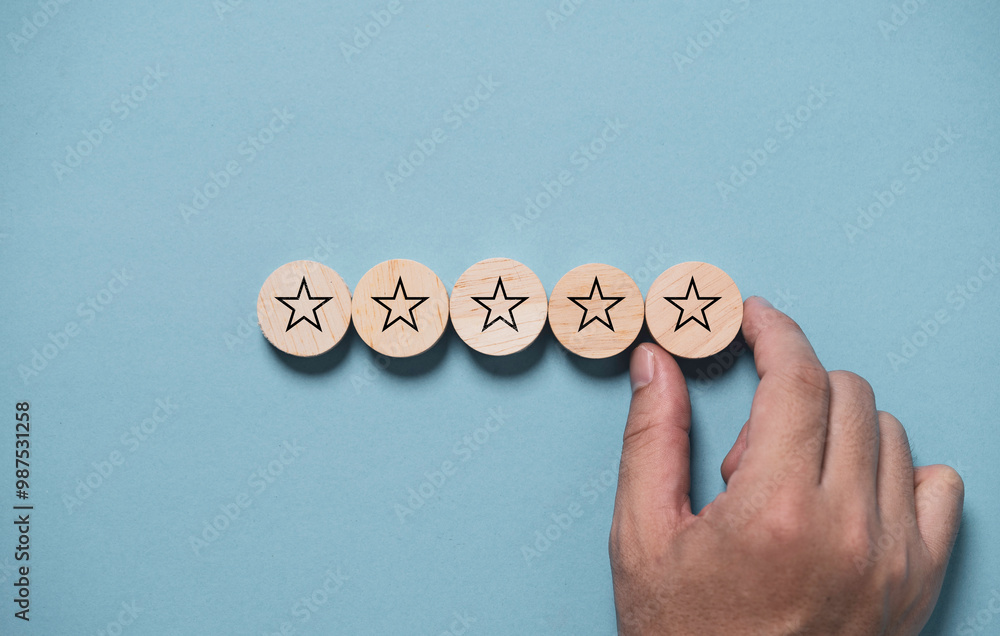 Poster hand input five stars on wooden block and blue background for the best customer satisfaction and eva