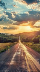Scenic landscape featuring an asphalt road winding through green hills at sunset