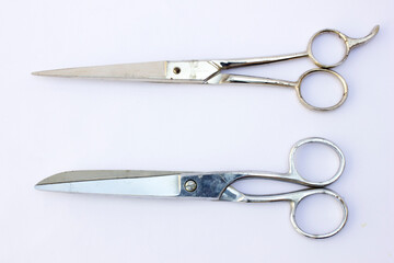 Functionality and Design: The contrast between the metallic sheen of the scissors and the matte background highlights their functionality. These tools are ideal for crafts, tailoring, or any context w