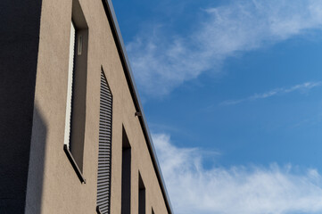 Facade of a modern building in the sun with blue sky