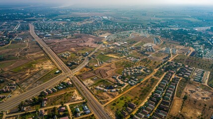 Fototapeta premium Aerial view of a sprawling suburban development with roads and houses.