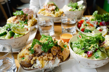 Table Full of Salads and Dishes