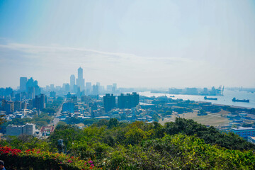 Fototapeta premium Kaohsiung, Taiwan, Republic of China, 01 25 2024: The landscape of Kaosiung port harbor, downtown, taiwan strait, and shoushan mountain 