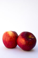 Two red apples. Apples can also be chopped into green salads, shredded into slaws, thinly sliced and placed on top of nut butter toast, stuffed into sandwiches.
