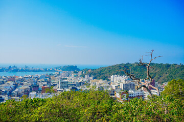 Obraz premium Kaohsiung, Taiwan, Republic of China, 01 25 2024: The landscape of Kaosiung port harbor, downtown, taiwan strait, and shoushan mountain 