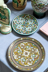 Plates on the table. Classic Crimean Tatar painted dishes. Ceramics crockery