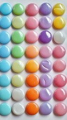 Obraz premium Candy buttons in a variety of bright pastel colors arranged in rows