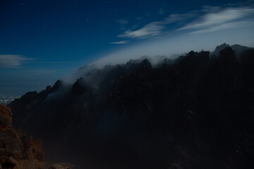 Night view of sulphurous smoke from Merapi Volcano coming out of the rocks in black silhouette