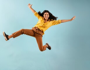 Obraz premium Happy Woman Jumping with Energy Against a Blue Background