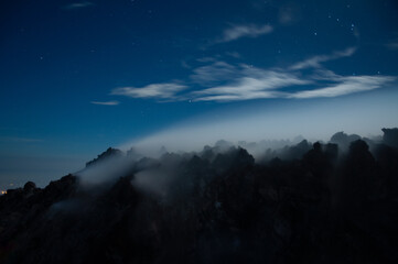 Night view of sulphurous smoke from Merapi Volcano coming out of the rocks in black silhouette
