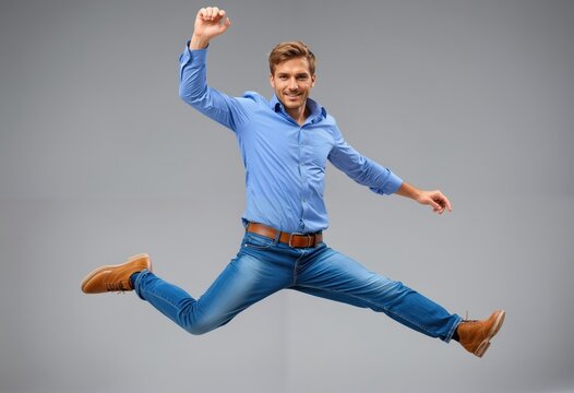 A man in a blue shirt and brown belt, mid-air with arms outstretched, is the central figure in a dynamic, energetic scene against a plain gray background