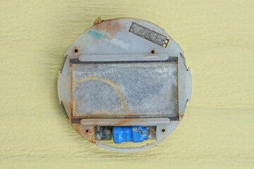 one old gray disassembled electronic wristwatch lies on a yellow table