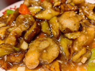 Chinese cuisine eggplant to share with people eating with chopsticks and plates bowls