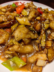 Chinese cuisine eggplant to share with people eating with chopsticks and plates bowls