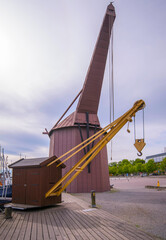 Harbor cranes, old tread mill and a small cargo crane on the island Skeppsholmen, a midsummer day in Stockholm