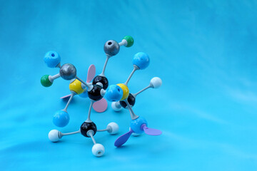 Simulate Shape of covalent molecules on a blue background. Soft and selective focus.