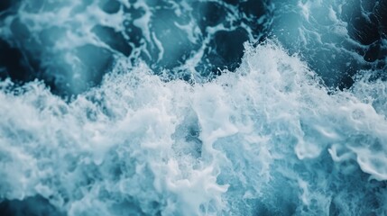 An aerial shot of turbulent ocean waves crashing with white foam against the shoreline, depicting the raw power and beauty of the sea in motion, in vivid detail.