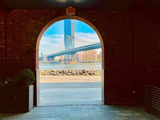 Manhattan bridge  look through red brick Arch along river at new york city usa