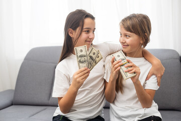 Portrait of two business children with US Dollars as symbol of bribe in an envelope.