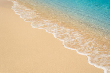 wave on sand beach top view.