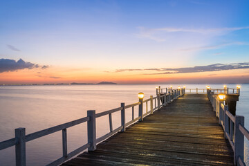Fototapeta premium wooden bridge with sunset on the sea