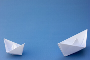 Fototapeta premium Two White Origami Boat. Two miniature boats ready for adventure.