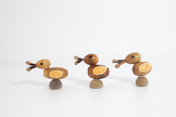 Row of ducks made of acorns with natural details. Creative autumn Craft, Perfect for fall themed decor,
