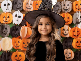 Fototapeta premium Children at Halloween festival in carnival costumes. Funny Halloween Kids with pumpkin