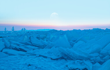 Snowy ice hummocks with transparent blue piles of ice at sunset - Baikal Lake, Siberia