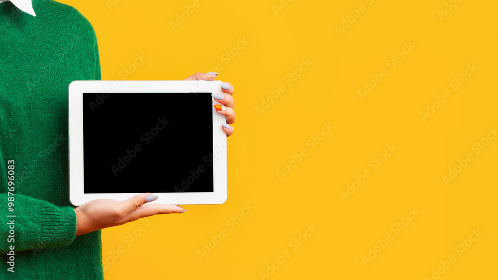 Poster useful application or website. unrecognizable afro teenager holding tablet with blank black screen, 