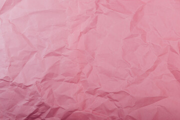 Texture of crumpled pink eco-paper. The concept of using natural materials for packaging.