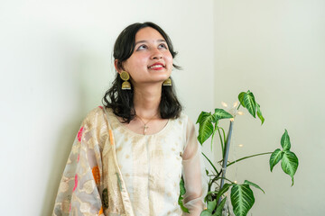 Beautiful Asian Female in Kurtha for Diwali giving Expressions & Gestures with LED Christmas Lights