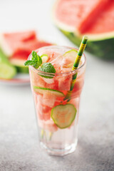 Summer infused water. Glass of tasty cold watermelon lemonade on the table