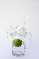 Water Splashed by a sliced lime throw down in the glass of water.