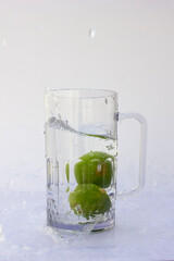Water Splash made by a sliced lime, throw down in the glass of water. Lime kissed by water.