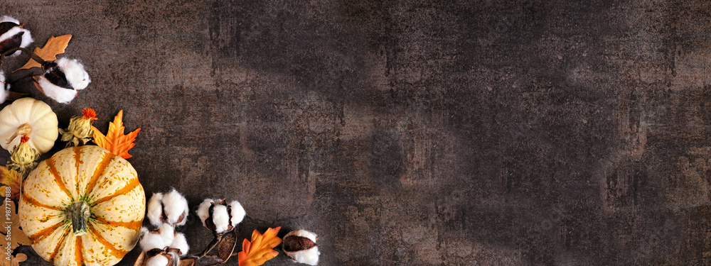 Poster fall corner border of white pumpkins and natural decor. top down view on a rustic dark stone banner 