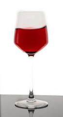 Red wine in a glass with splash isolated on white background