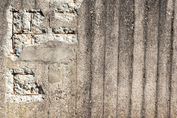 Broken concrete wall with details of ferroconcrete structure as reinforced concrete with metal skeleton shows damages and ailing and aging concrete wall or bunker protection in war time after attacks