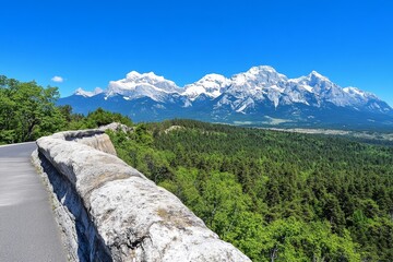 A scenic view of a mountain range, with snow-capped peaks and a pristine forest below, highlighting the majesty of the natural world