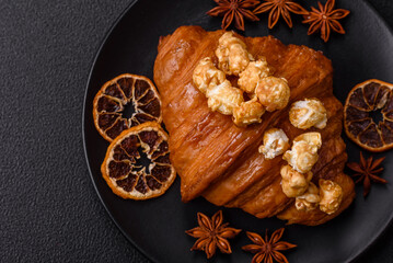 Sweet crispy croissant with salted caramel and glazed popcorn